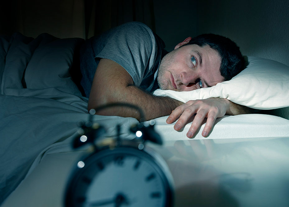man in bed with eyes opened suffering insomnia and sleep disord